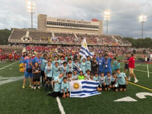 Uruguay youth teams at the Youth World Challenge 2026 in New York, holding the Uruguayan flag