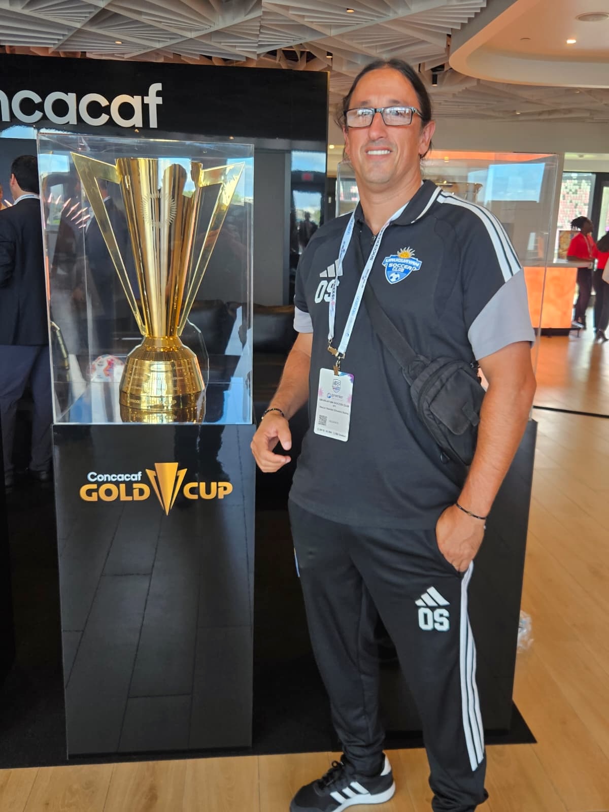 Oscar Silveira beside the Concacaf Gold Cup trophy during Soccerex Miami 2026.