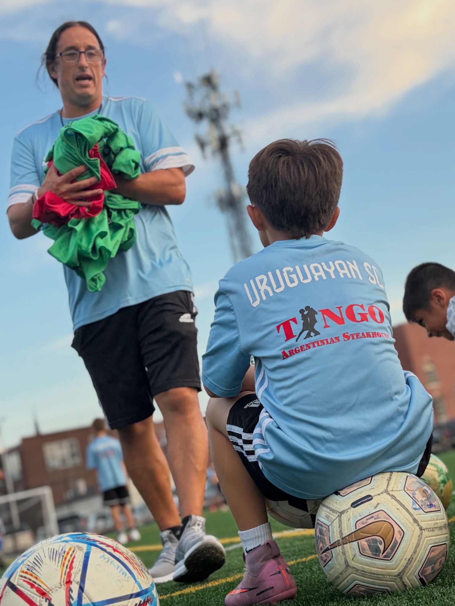 Uruguayan Soccer Club coach supporting young players during an academy event