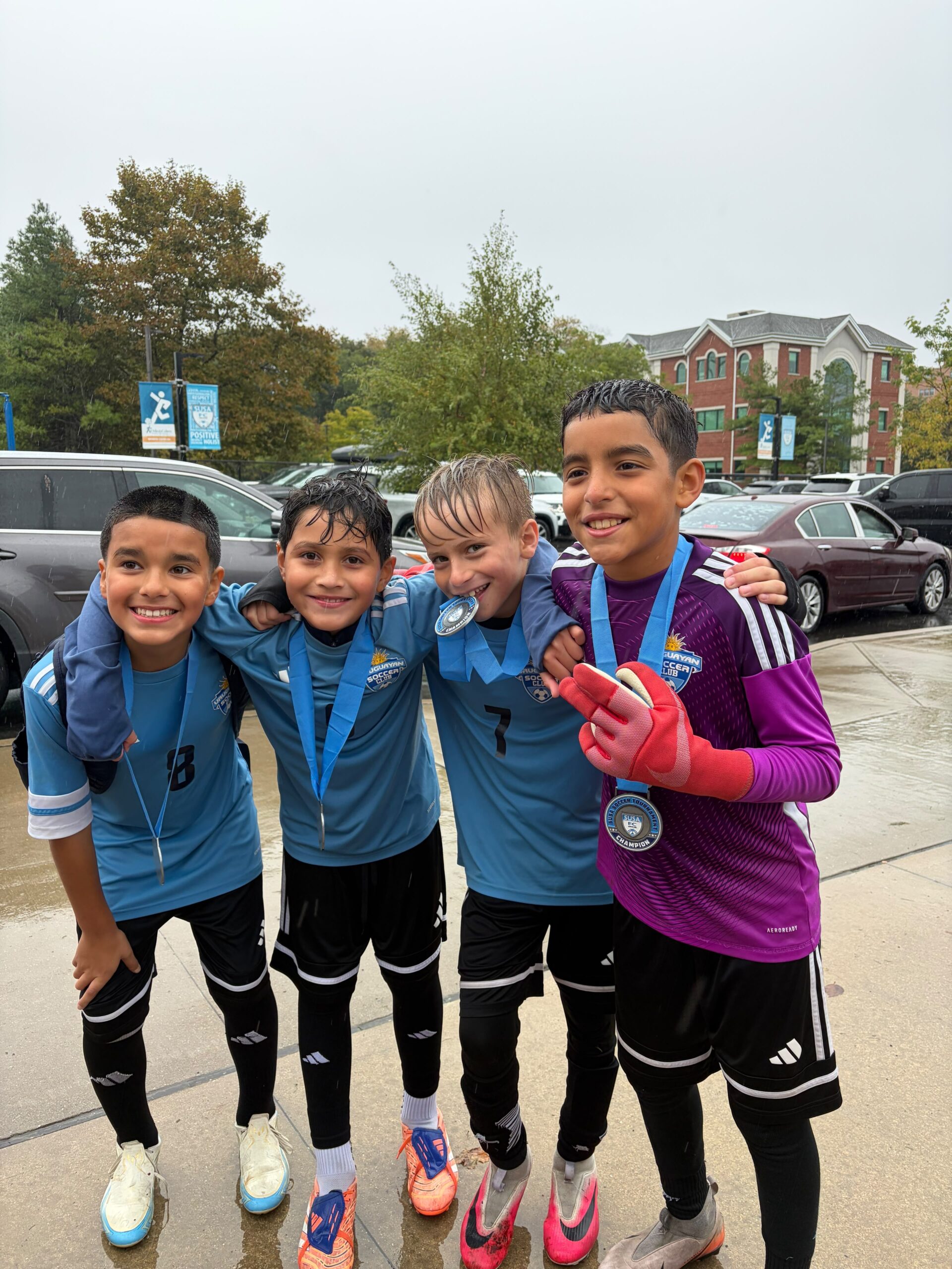 Uruguayan Soccer Academy players celebrating with their Columbus Cup medals.