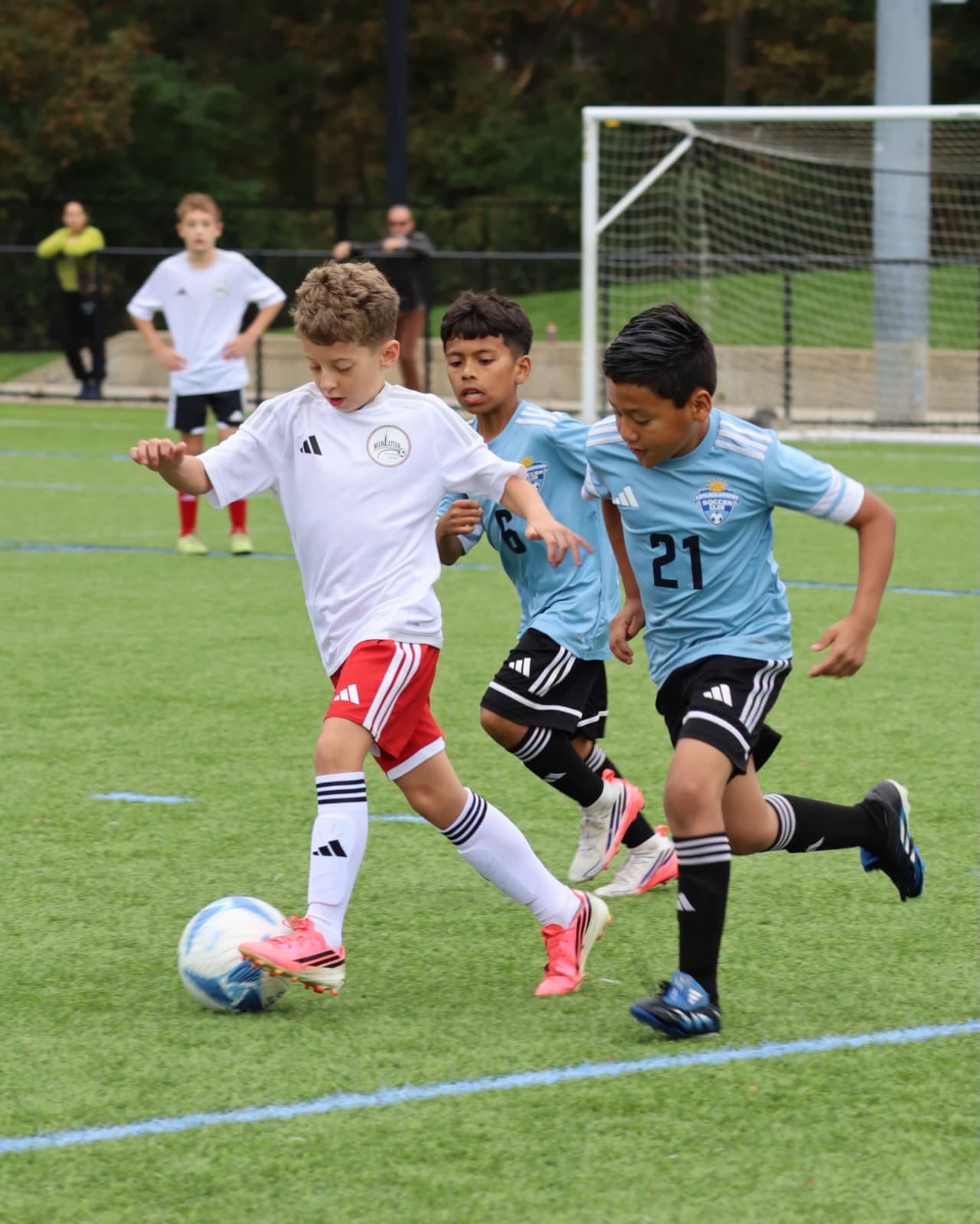 Two Uruguayan Soccer Academy players competing for the ball at the Columbus Cup.